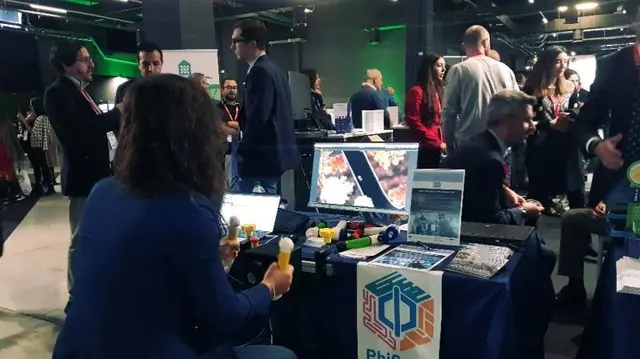 A visitor tries the PhiCube grips at the Cluster Tav stand during the SMAU trade fair.