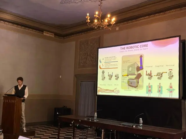 Giovanni Tauro, co-founder and Chief Product Officer of Rehabilia Technologies, presenting PhiCube's robotic core from a lectern at the Startup Breeze 2025 Pinwheel Pitching Stage in Florence.
